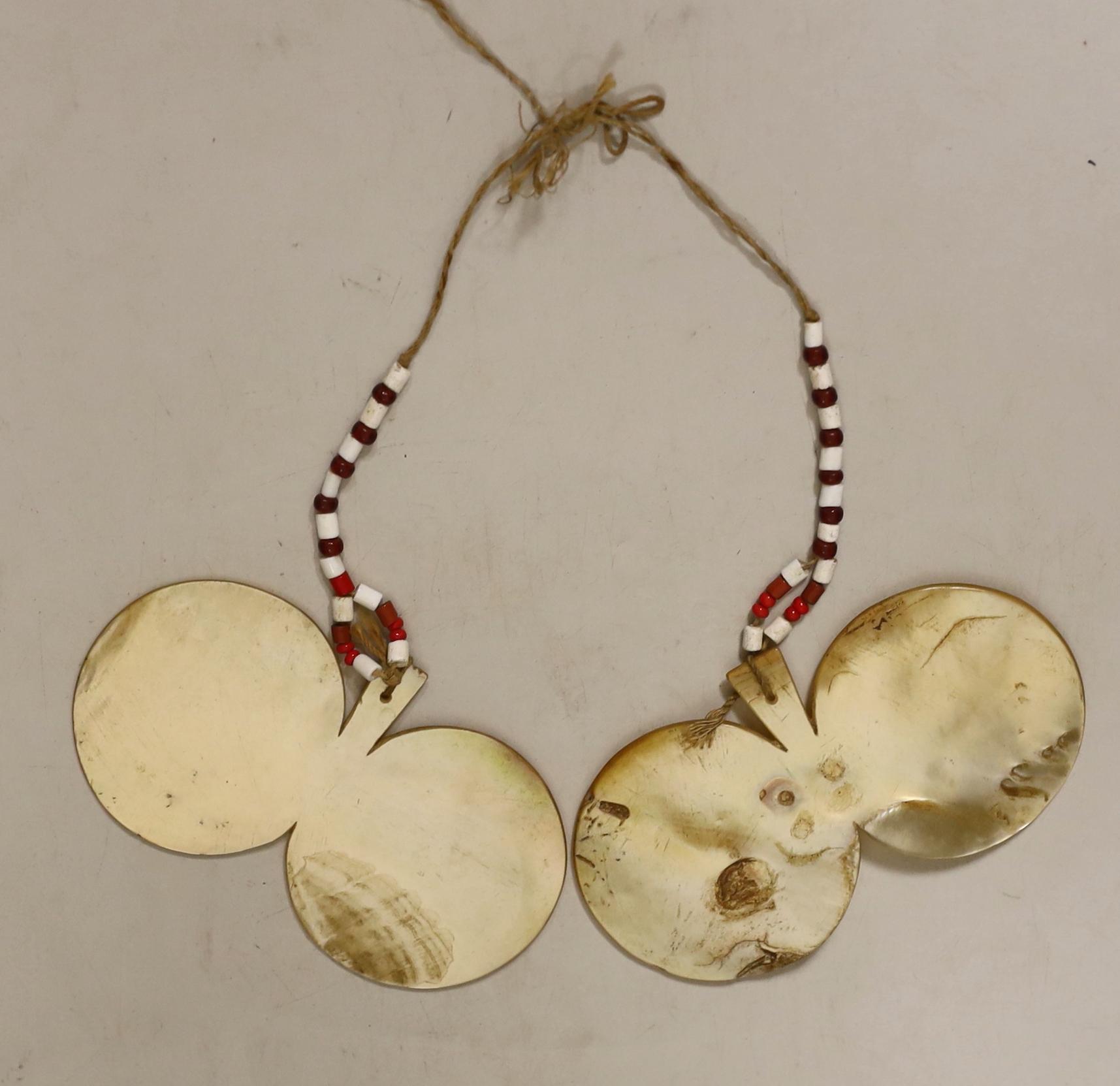 A pair of Philippines mother of pearl bawisak earrings, Naga tribe, each 11.5cm. Provenance – a European Private collection, thence by family descent. Ethnographica from the same collection was sold by Sotheby’s, Paris,